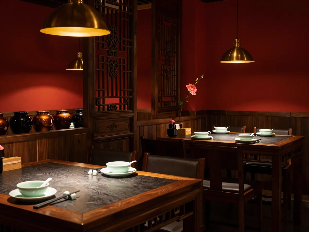 AI-generated photograph: A dark, warm dining room with deep red lacquered walls, low brass lamps over wooden tables, carved wooden lattice screens and a row of glazed clay pickle jars along a shelf